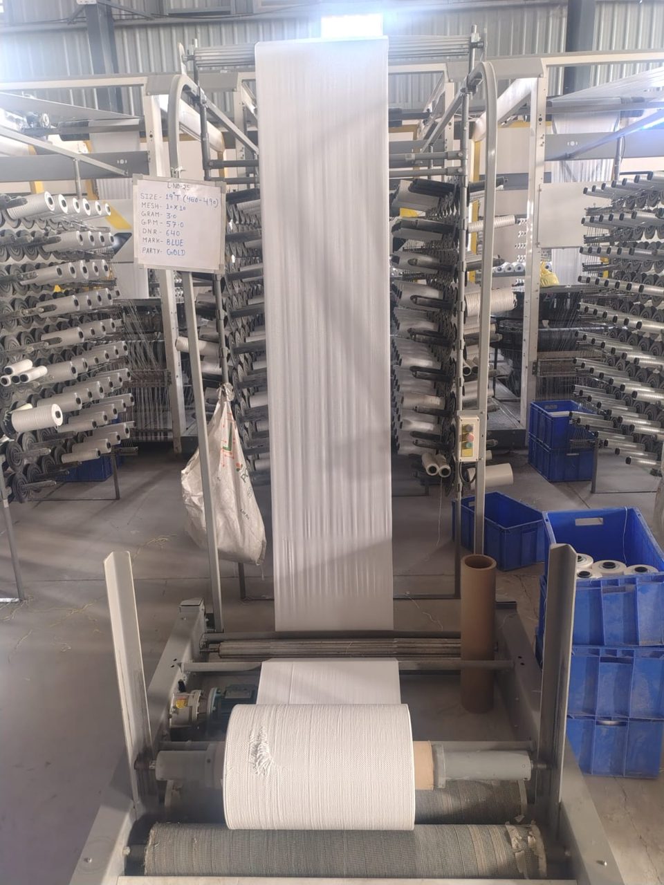 White woven fabric on winder with job card