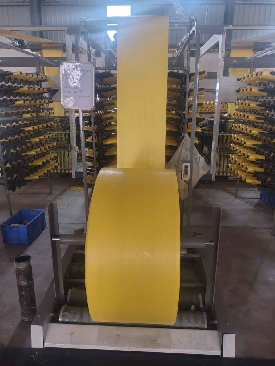 Roll of yellow woven fabric on winder