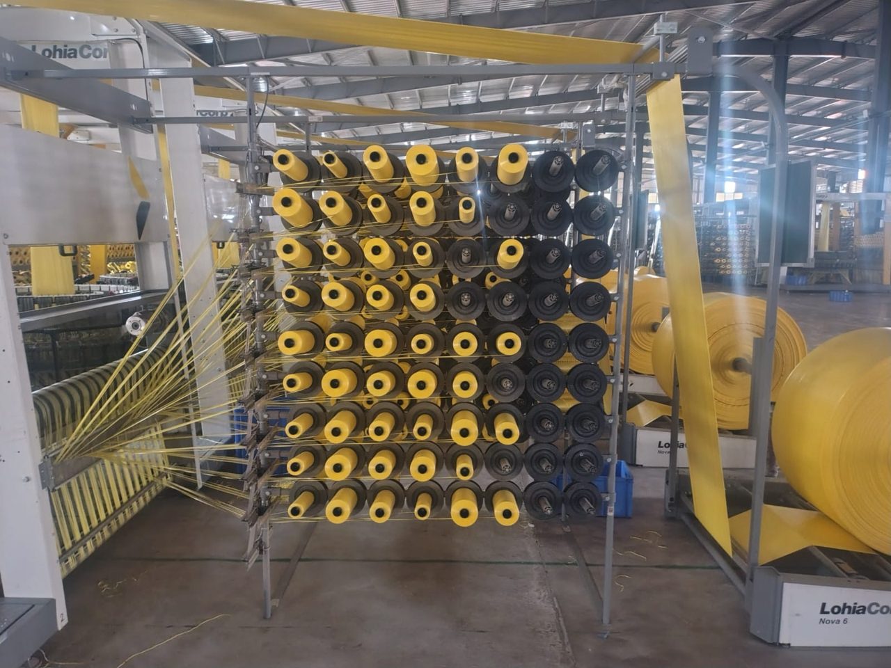 Creel of yellow and black yarn bobbins