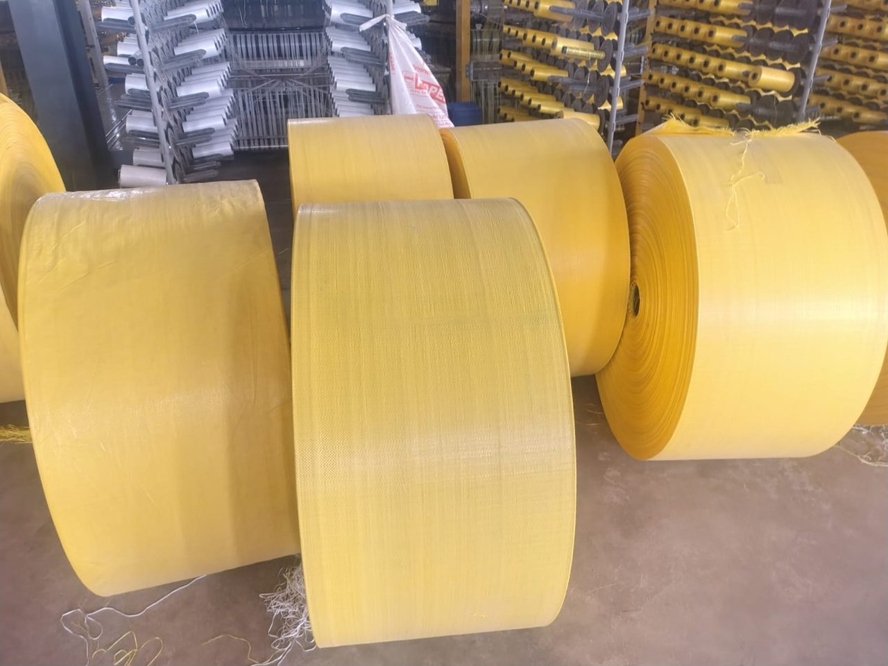 Large rolls of yellow woven fabric