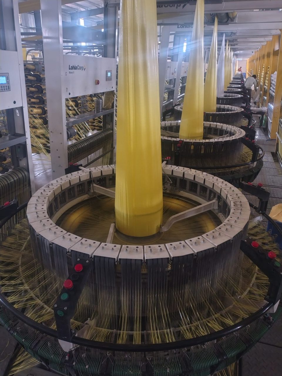 Circular looms weaving yellow fabric